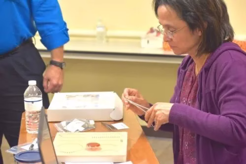 Medical professionals practice suturing